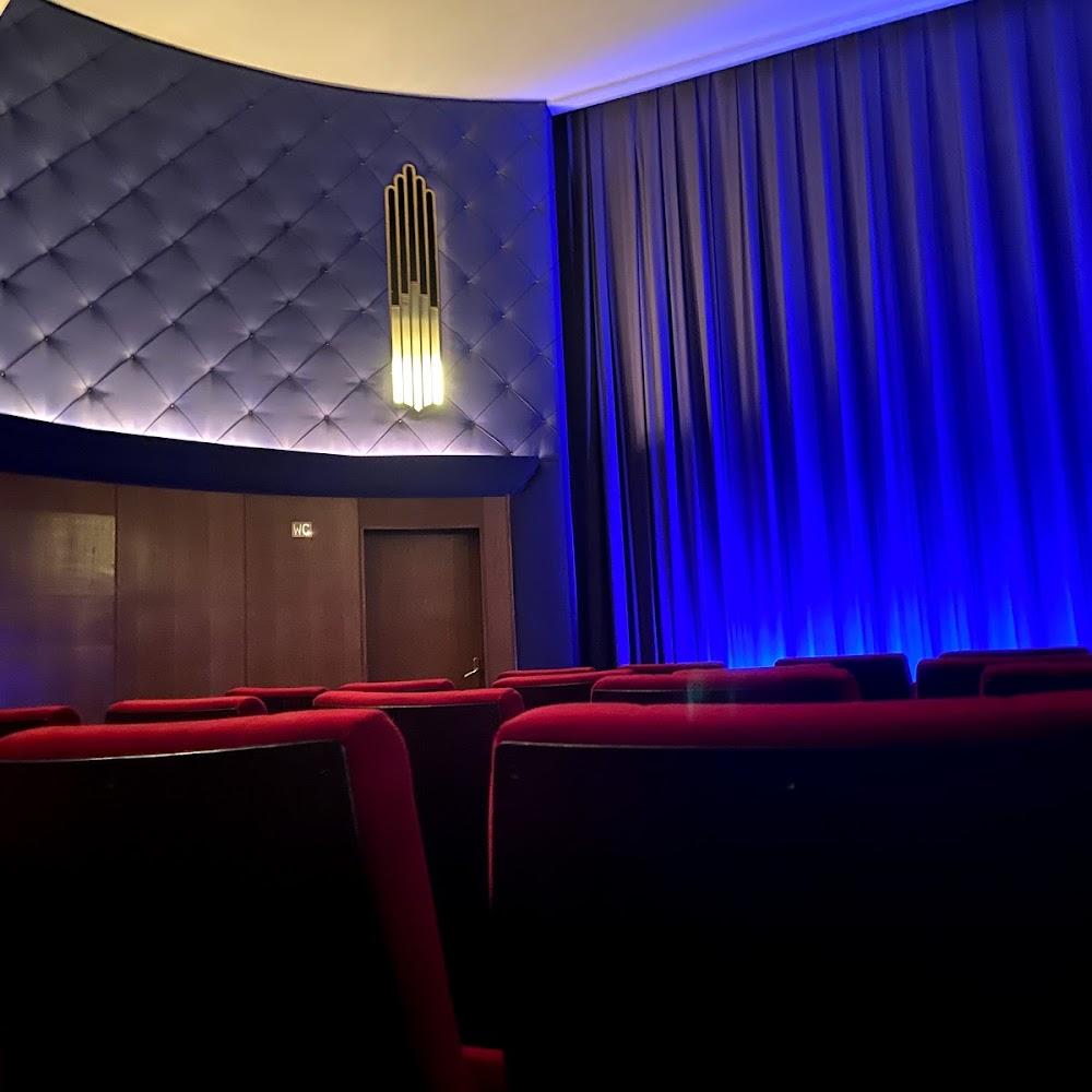 Red seats in an empty movie theater.